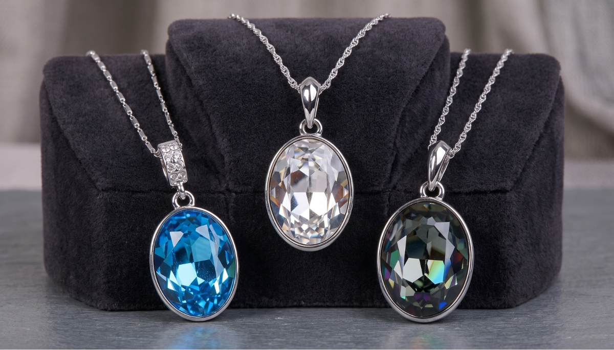 Three Ceri Jewelry Swarovski Elements pendant necklaces displayed on three black necklace busts