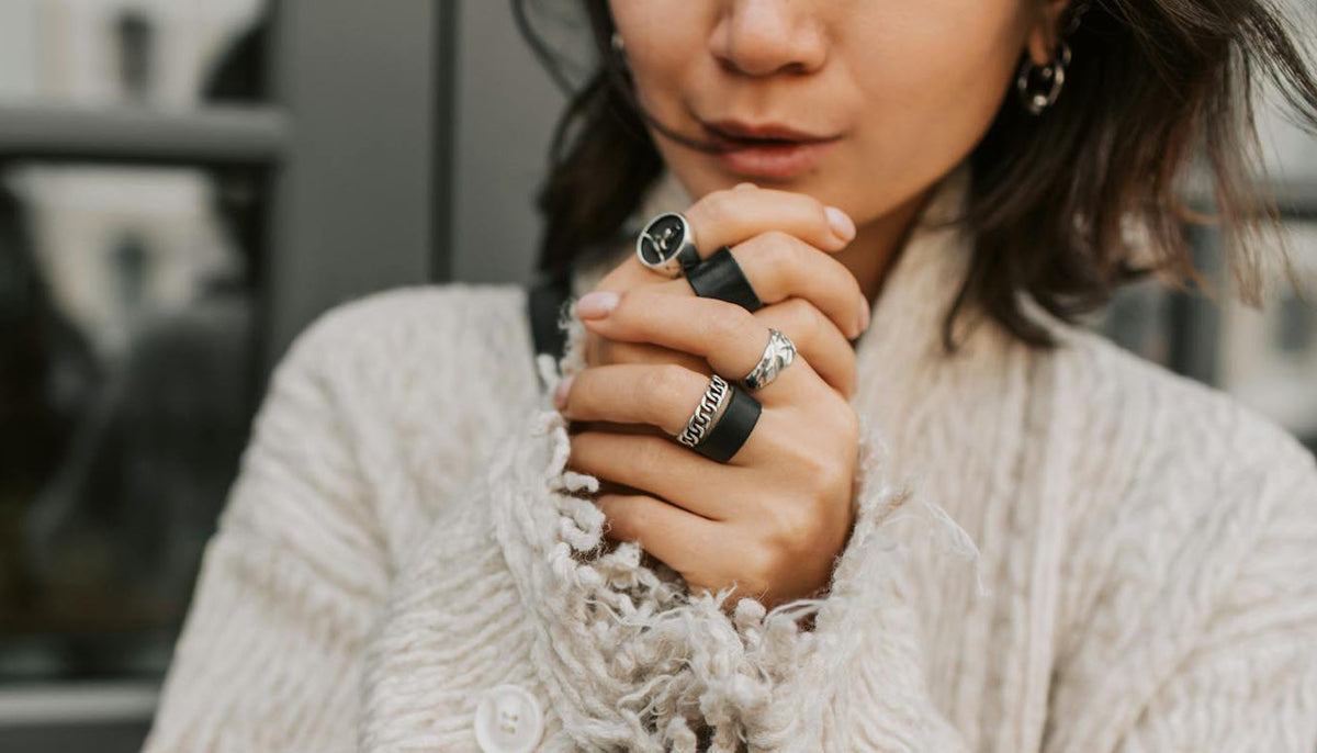 Woman in Beige Coat Wearing Layered Fashion Rings