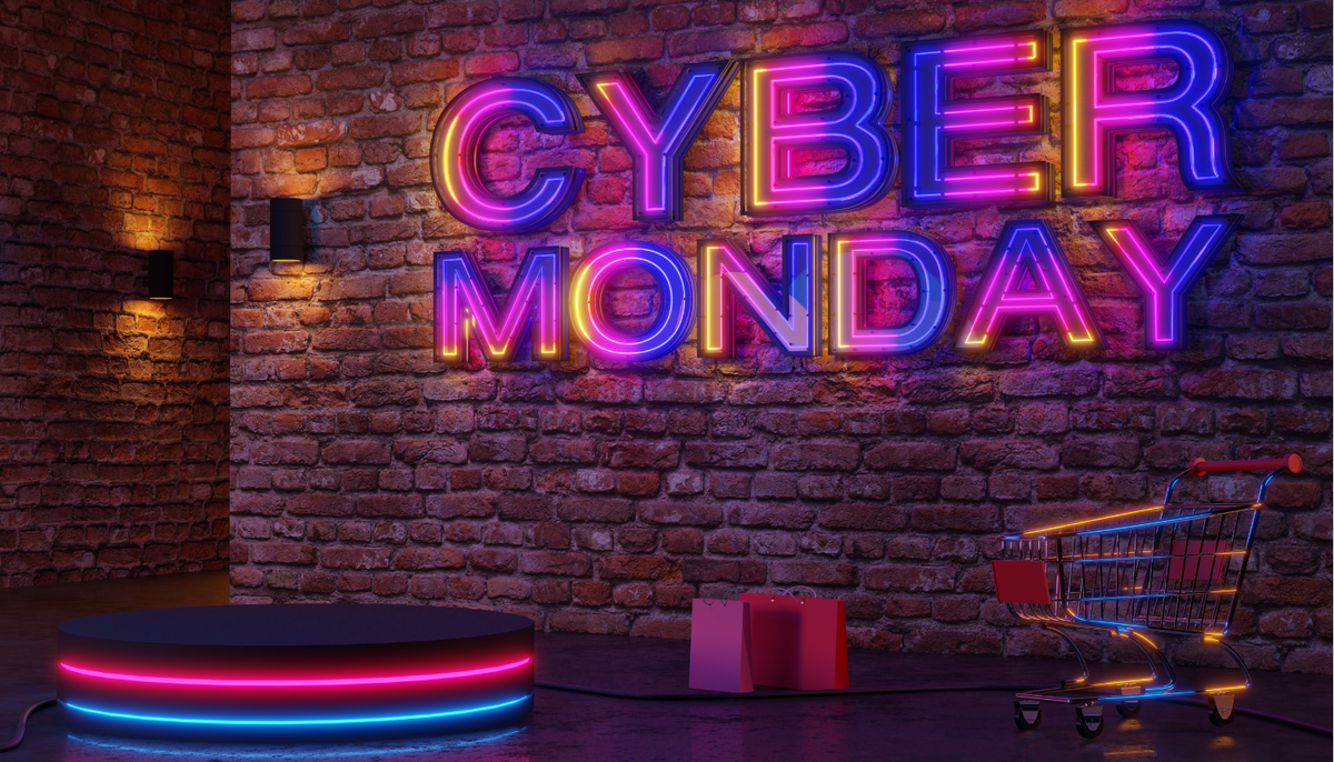 cart with an LED sign on the brick wall that says Cyber Monday