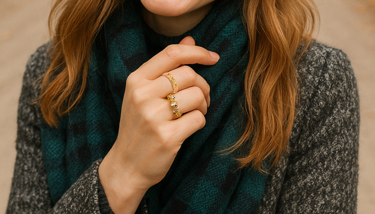 close up shot of a woman's hand wearing two gold plated rings one is the CJE3629 Wholesale Women's Stainless Steel IP Gold Top Grade Crystal Clear Infinite Daisy Ring