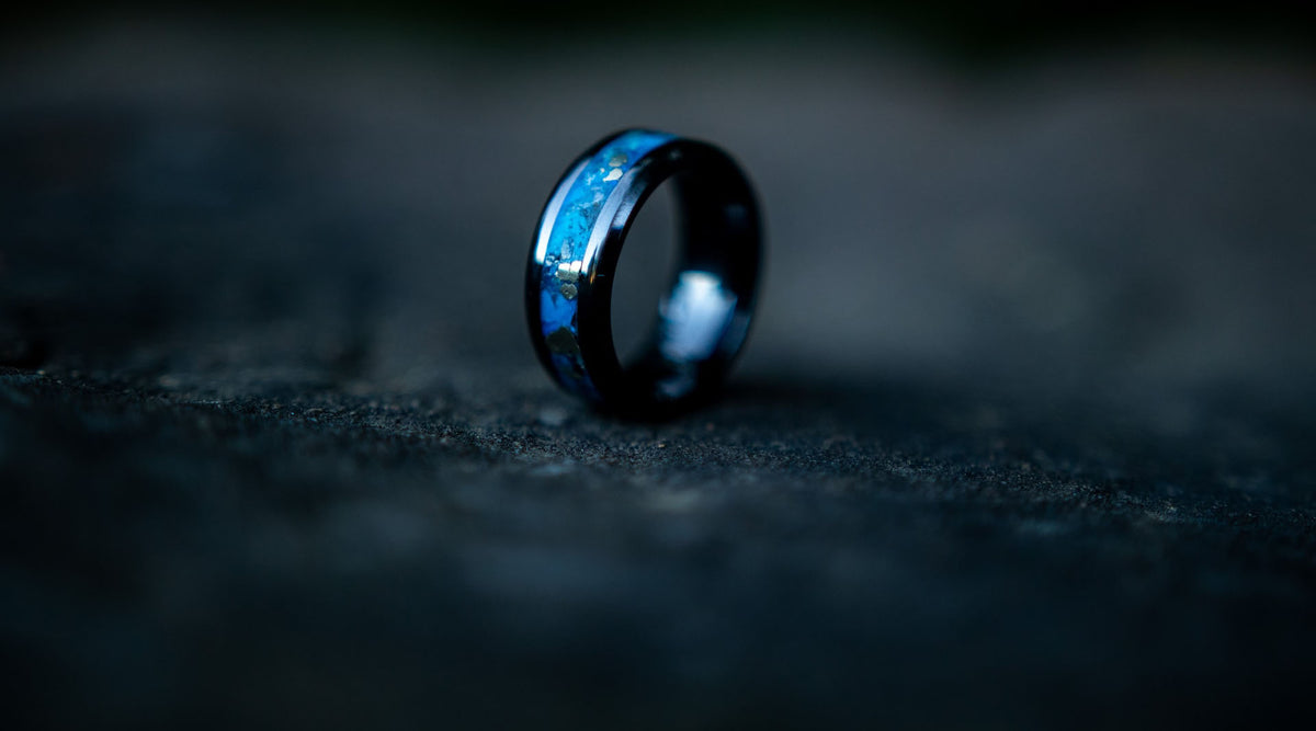macro photograph of a turquoise fashion ring with a dark background