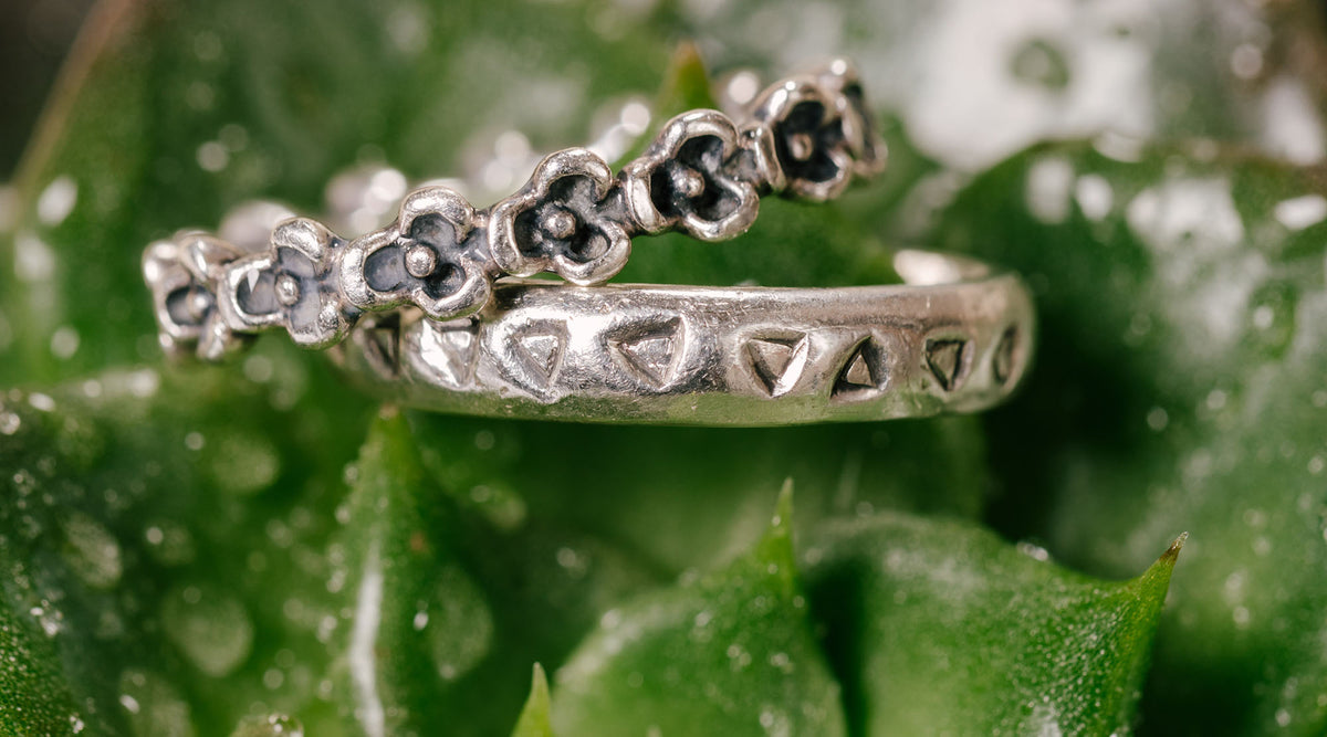 floral ring and minimalist fashion ring on plant