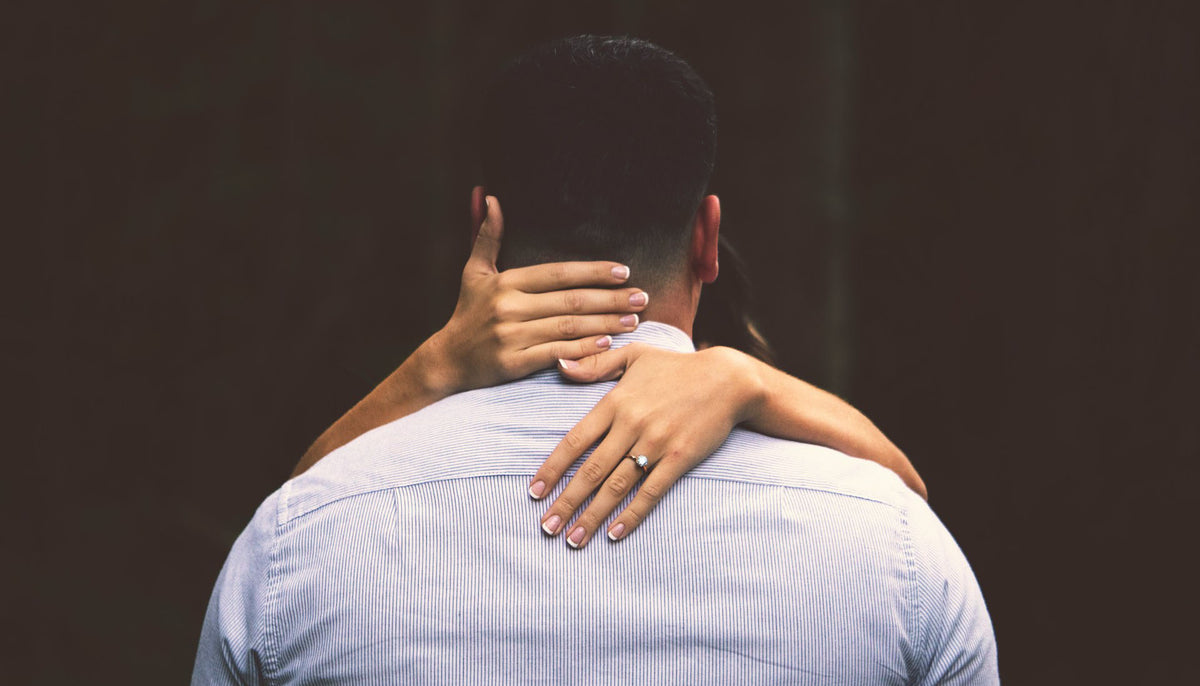 hugging newly weds with the bride's hand wearing a cz ring