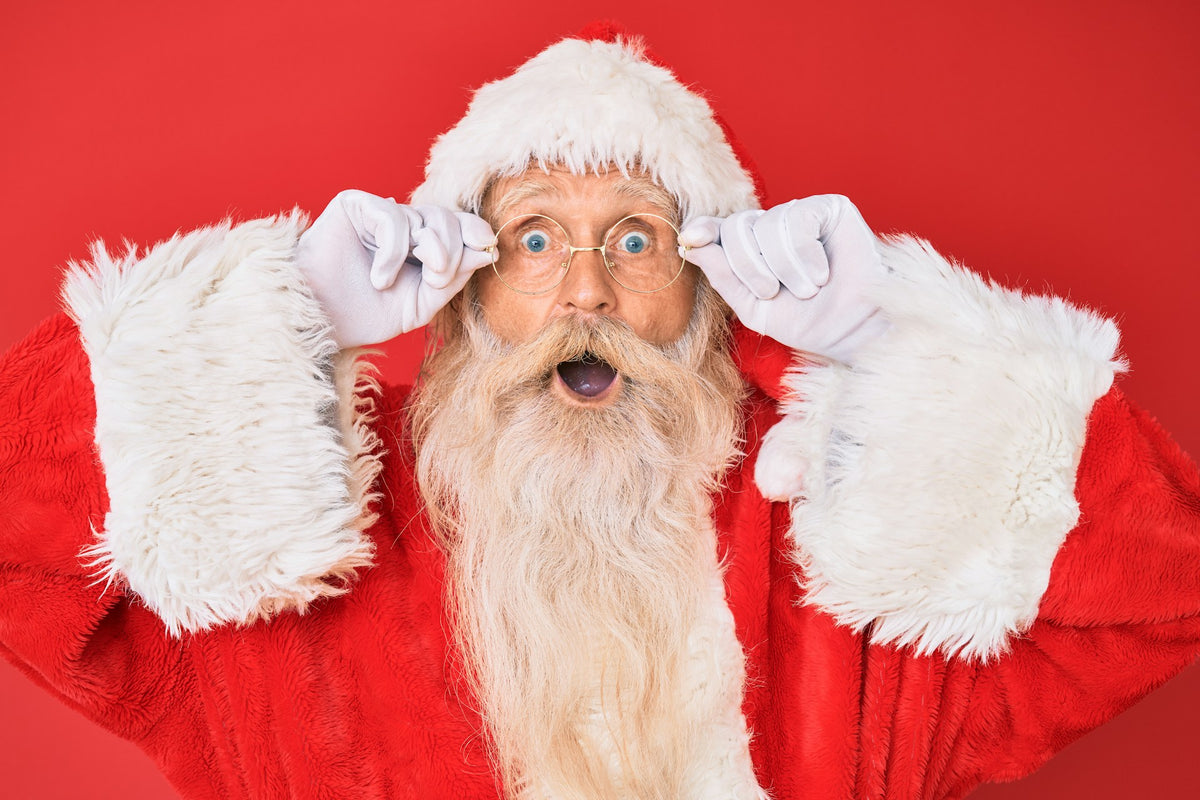 shocked Santa Claus against a red background