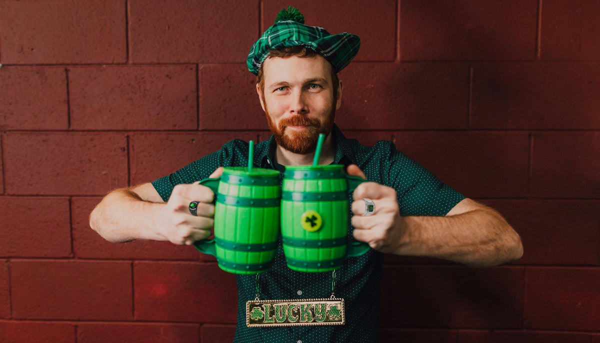 man celebrating st. patrick's day and wearing two Ceri Jewelry fashion rings with emerald colored stones