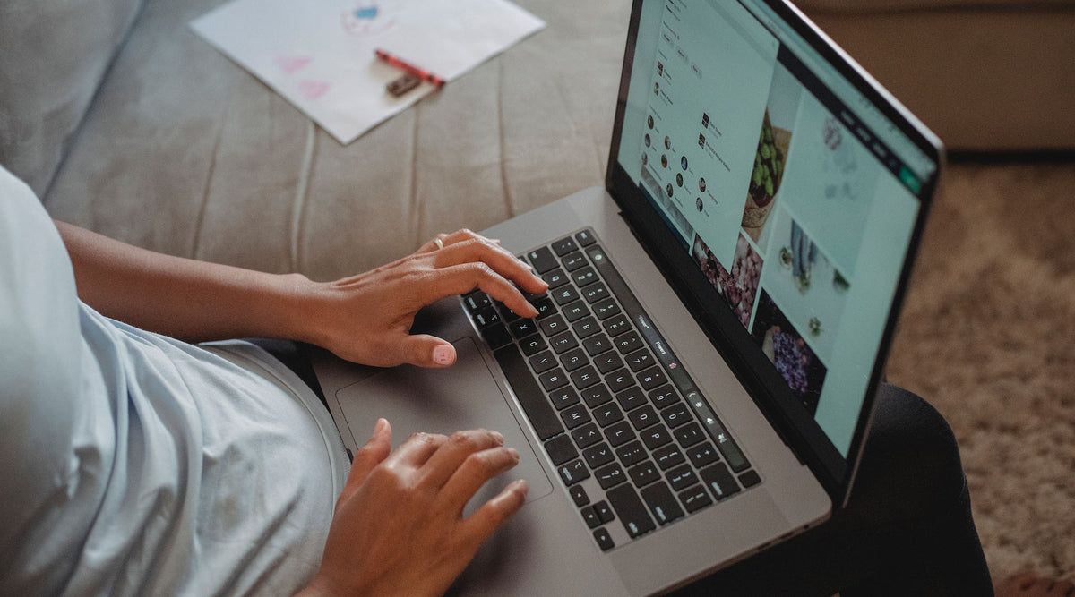 person typing on laptop managing online jewelry store