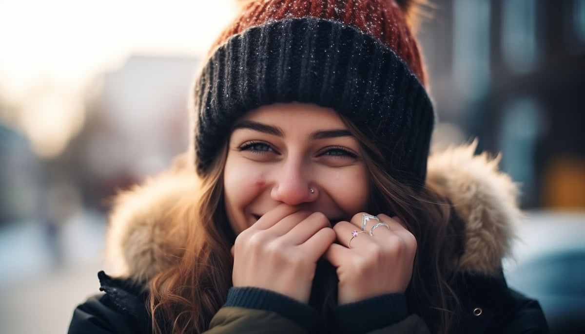 smiling woman wearing a bonnet and three stacked minimal fashion rings