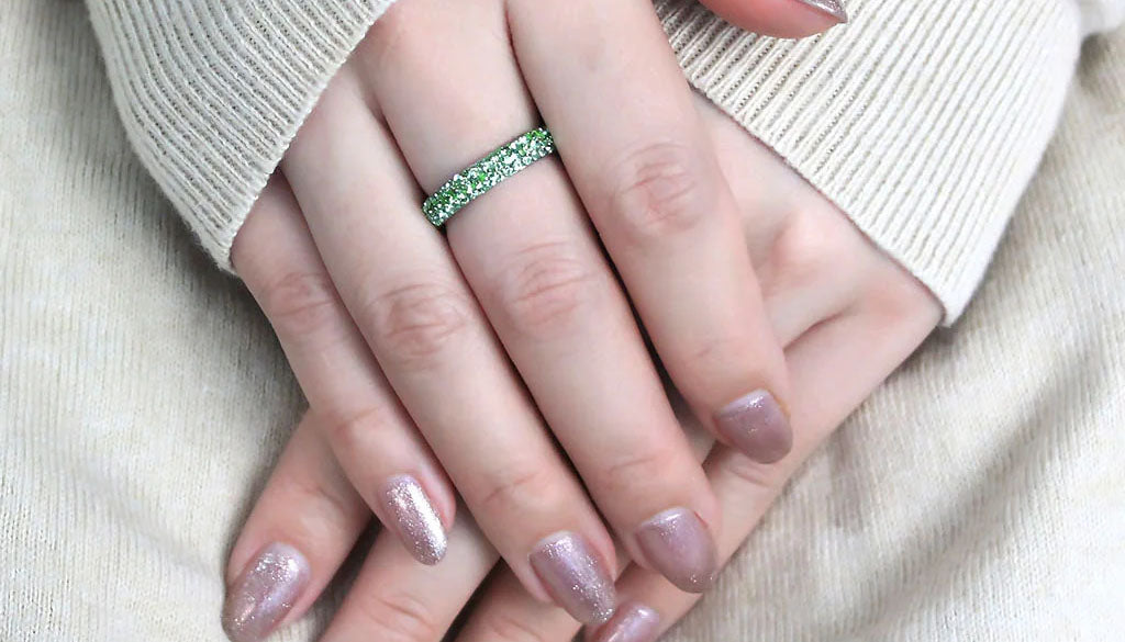 woman's manicured hand wearing CJ3537 Wholesale Women's Stainless Steel Top Grade Crystal Peridot Infinite Sparkle Ring