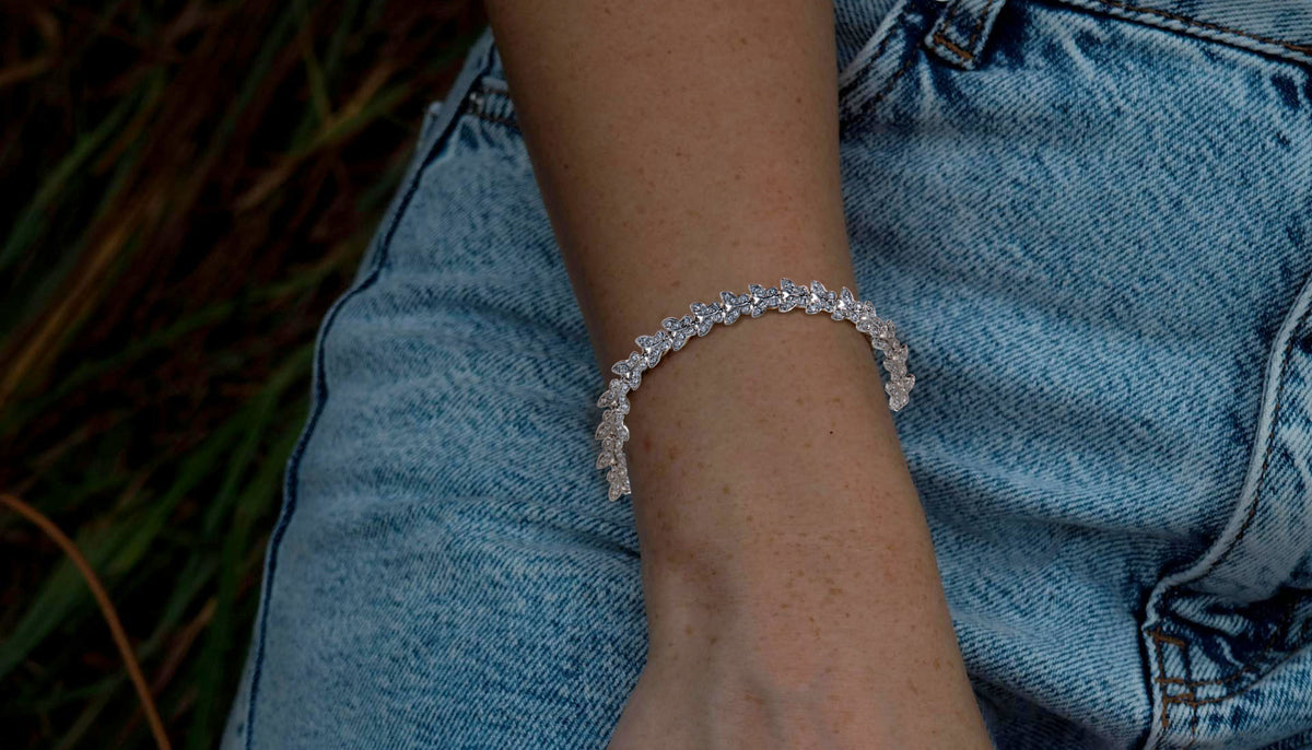 Close up shot of woman's wrist wearing B7105 Rhodium Swarovski Elements Butterfly Chain Bracelet