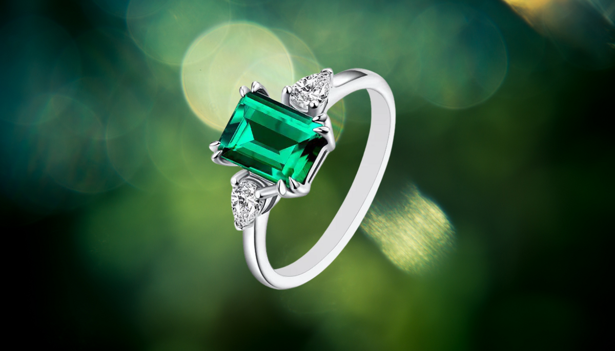 Emerald Cut Engagement Moissanite Ring in 925 Sterling Silver against a green bokeh background