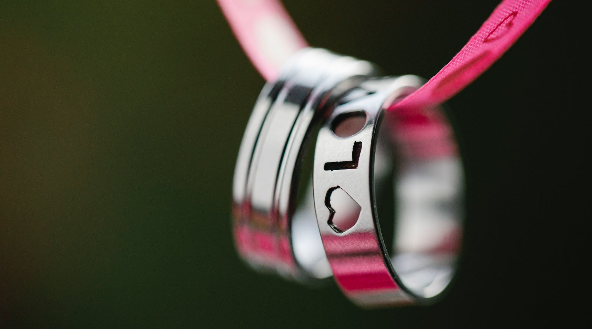 Engraved heart rings hanging on ribbon