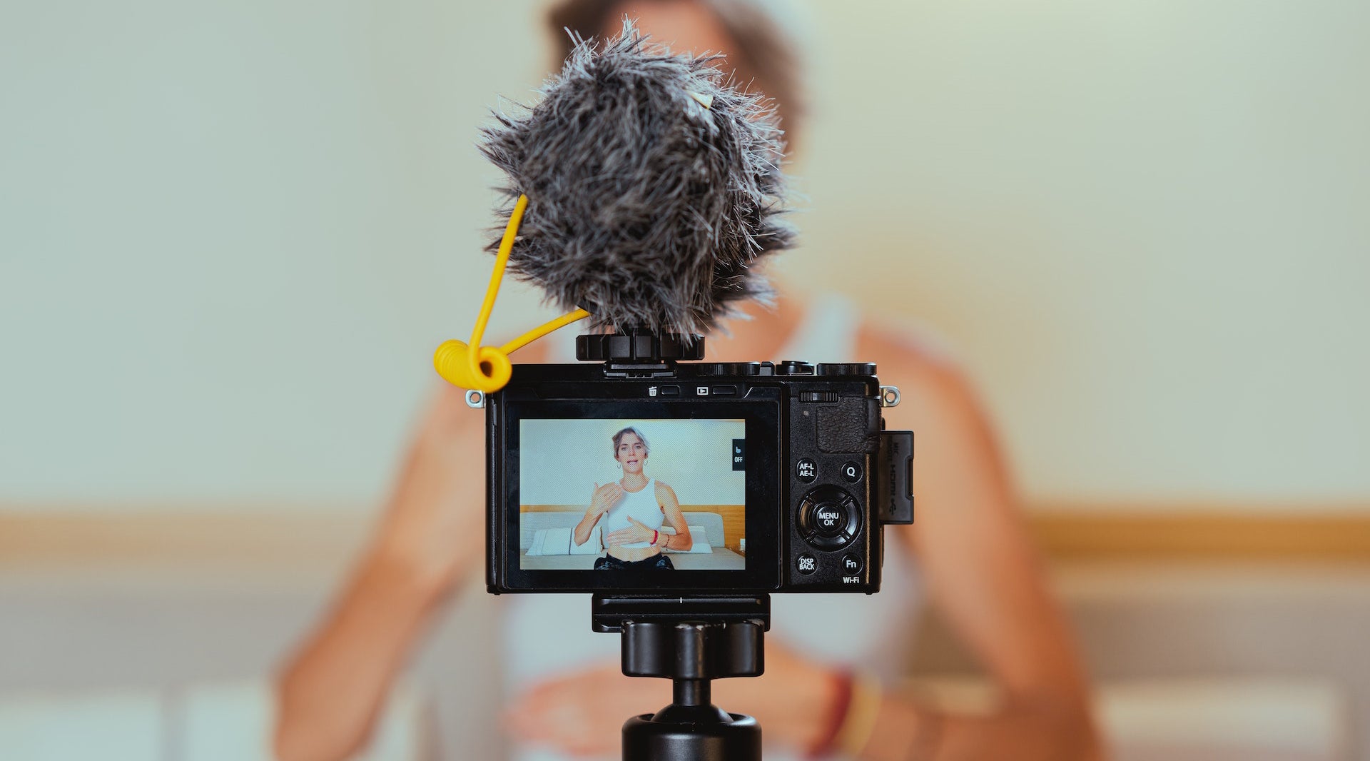 Shallow Focus Photo of a Video Camera Recording an Elderly Woman