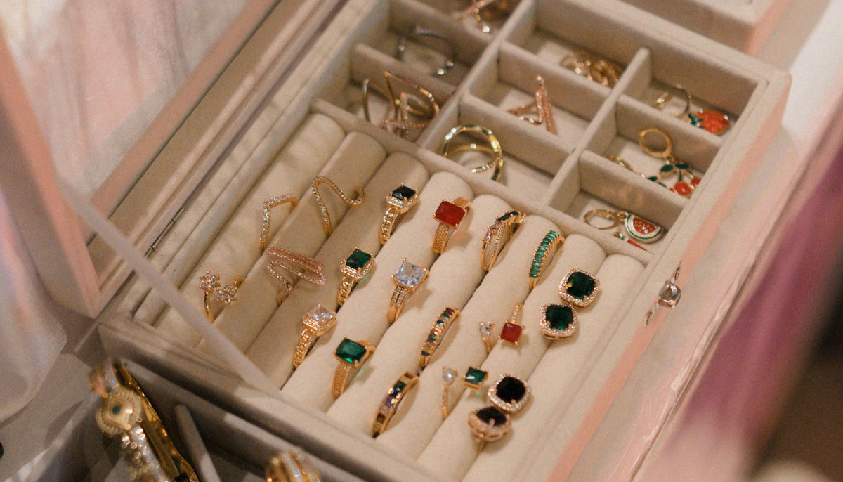 a top shot of fashion rings on display in an open luxurious jewelry boxes