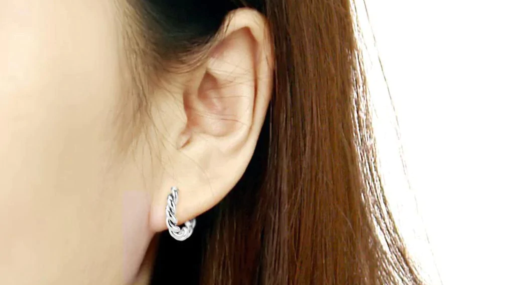 close up photo of a woman's ear wearing CeriJewelry minimalist stainless steel earrings