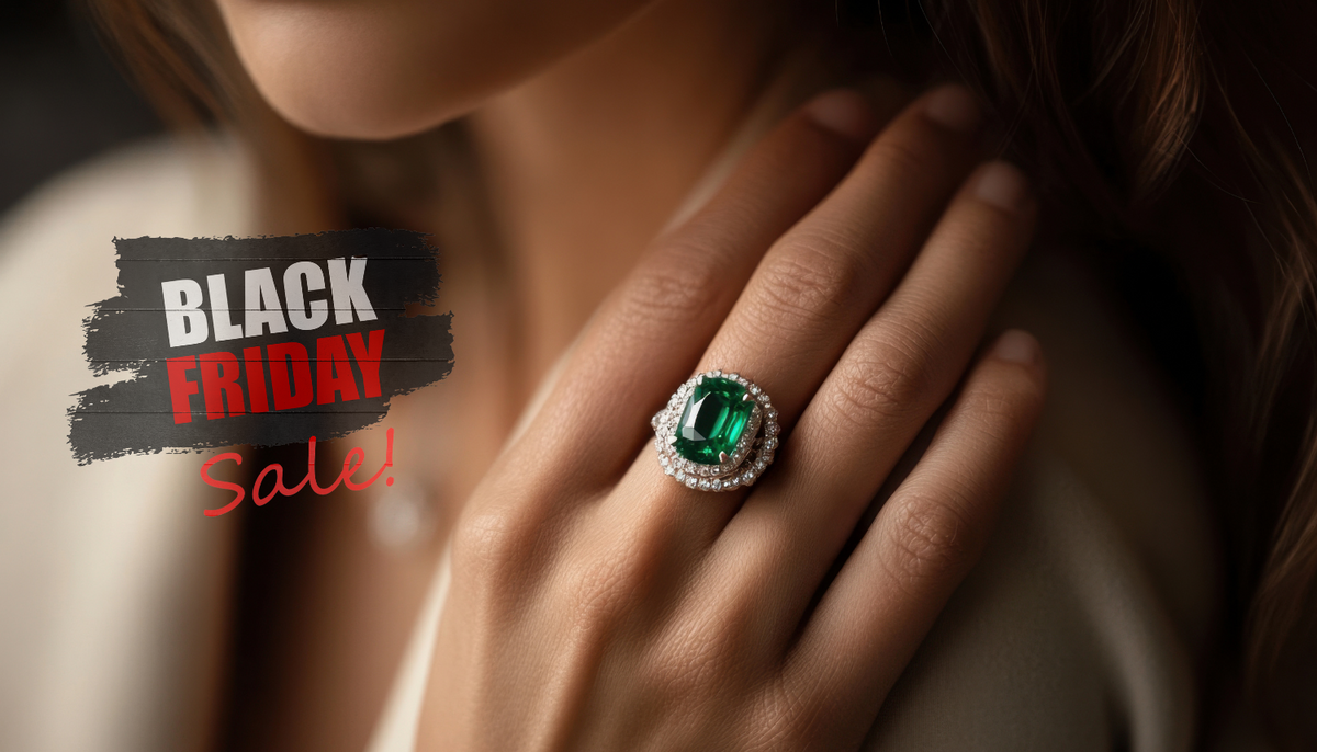 close up shot of a woman's hand on her shoulder wearing a green cz fashion ring with a black friday sale sign beside it