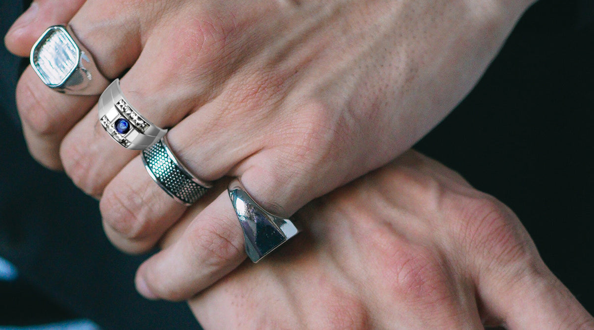 hand of man with stainless steel montana blue crystal ring