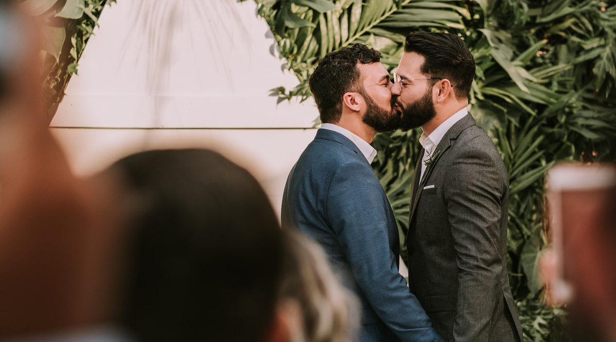 gay men kissing in their wedding
