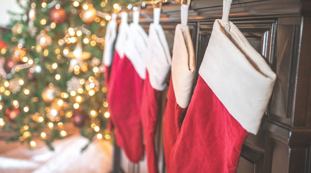 selective focus of red christmas stockings hung by the fireplace