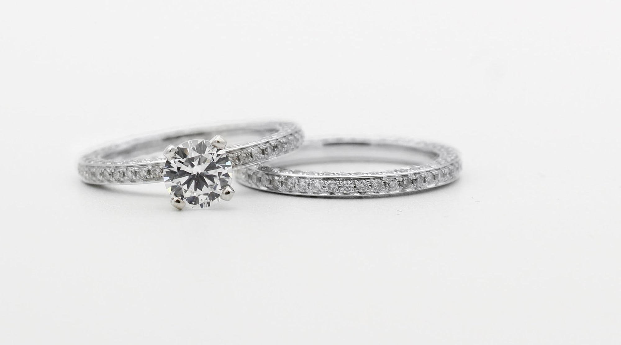 silver CZ fashion rings on a white surface