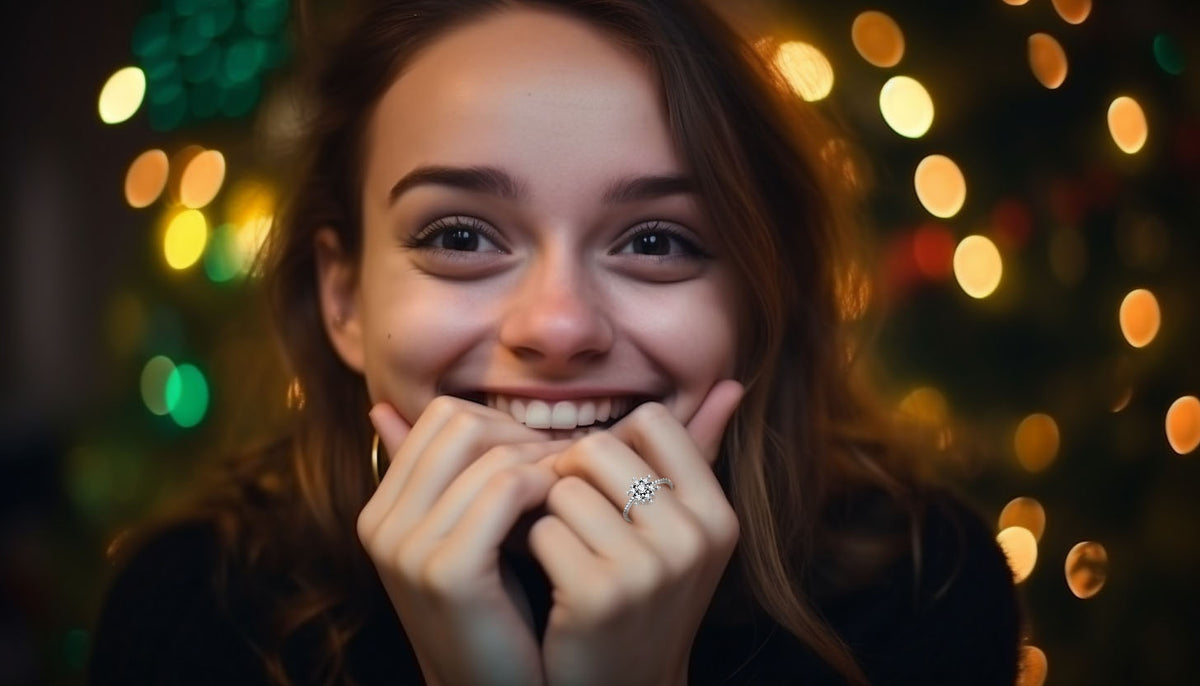 smiling woman with hands on her chin wearing a snowflake fashion ring from CeriJewelry
