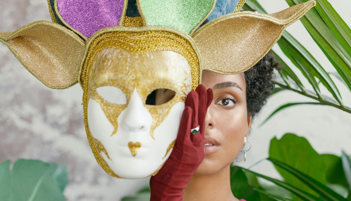 woman covering half her face with a mardi gras mask and wearing CJ52005 Wholesale Women's Stainless Steel Synthetic Emerald Round Solitaire Ring