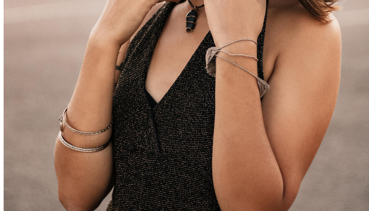 woman in a black v-neck top wearing stainless steel bangles