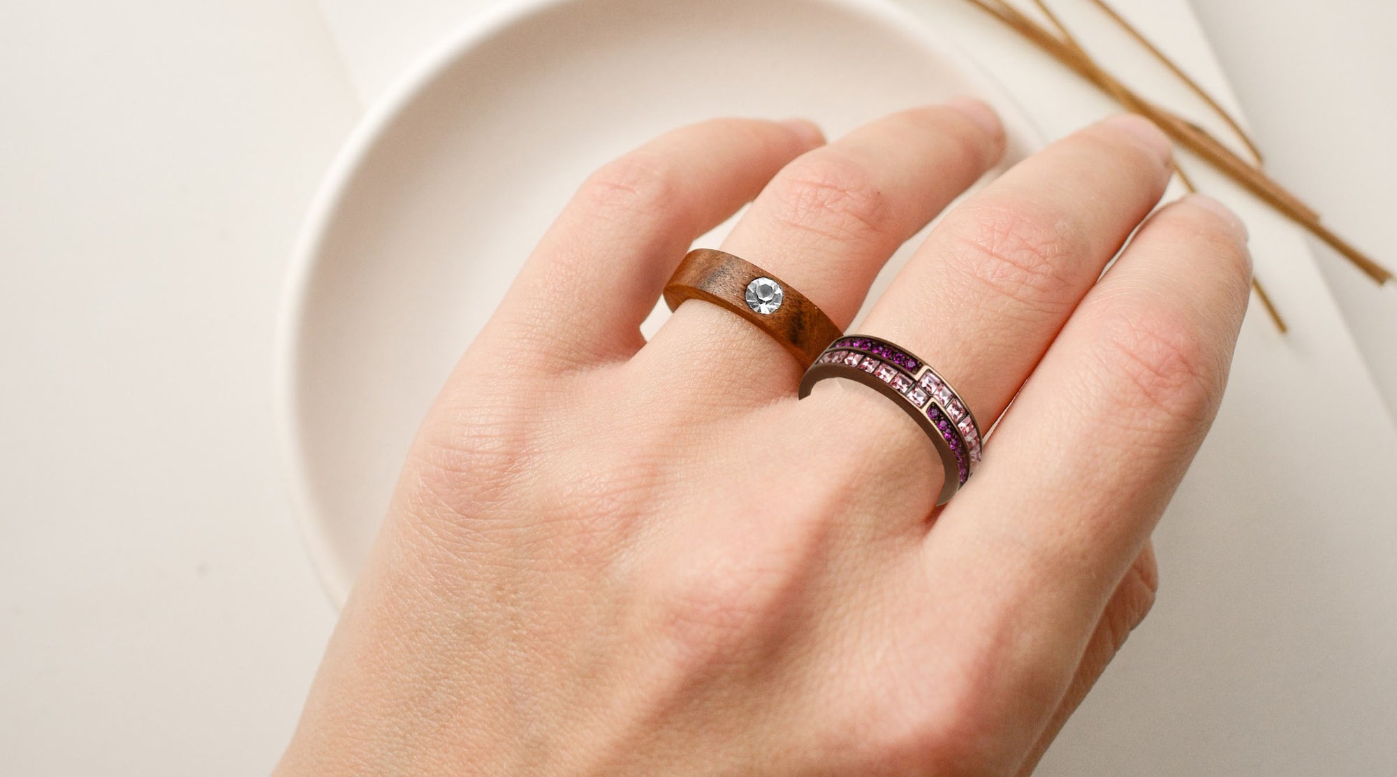 woman's hand wearing chocolate brown plated fashion rings